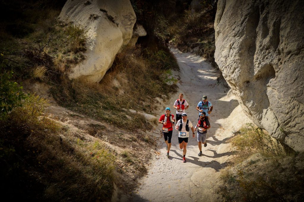 People Running on Dirt Road